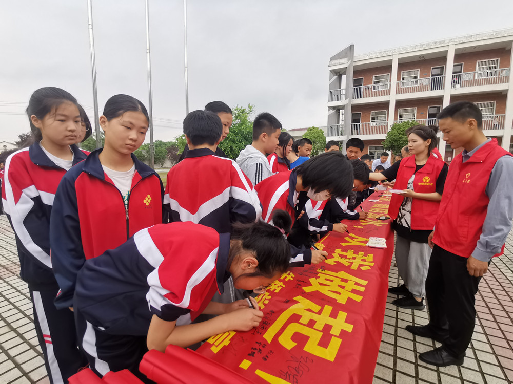 圖為朱橋學校學生在防溺水橫幅簽名時的情景2.jpg